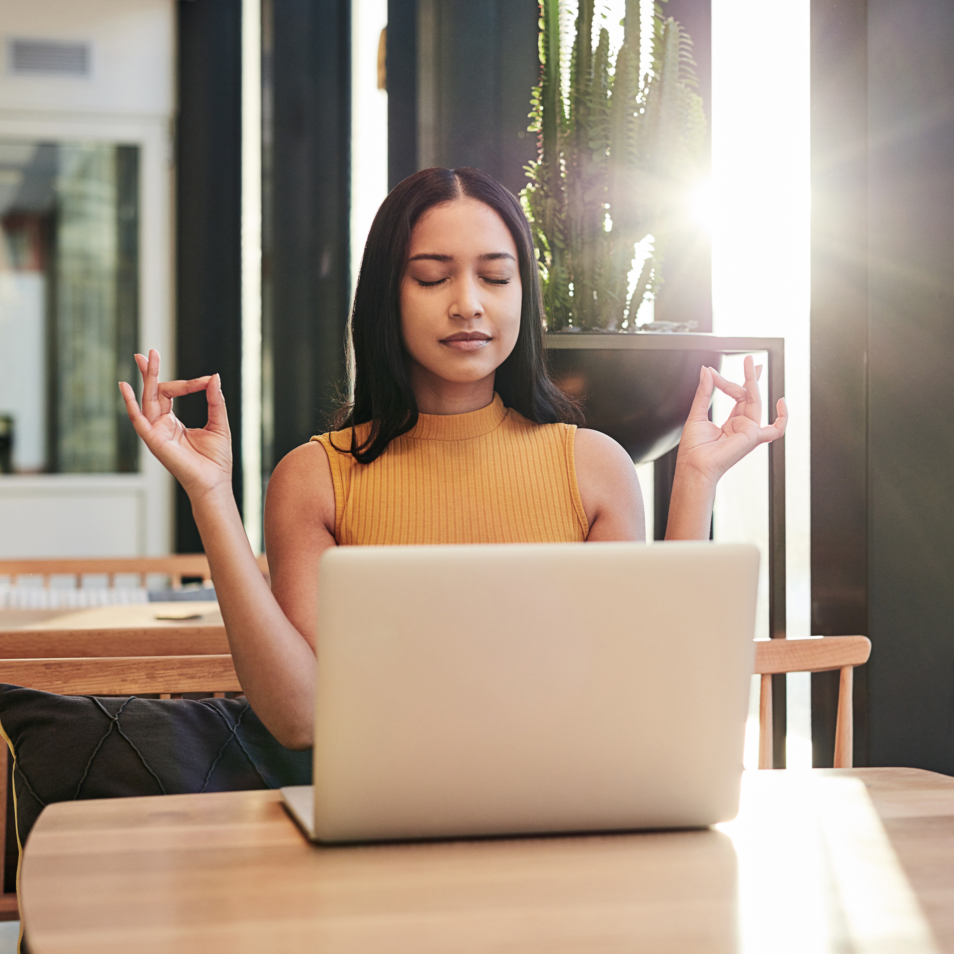 Female a desk in front of a computer in a bright room